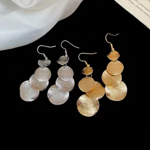 Irregular matte and glossy metal disc fringe earrings in gold and silver finish
