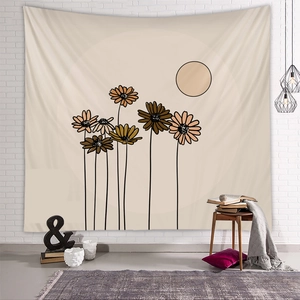 Bohemian sun and sunflowers tapestry hanging on a textured white brick wall interior