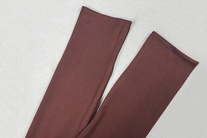 Detailed texture of dark brown elastic knit fabric accessories with a soft smooth finish