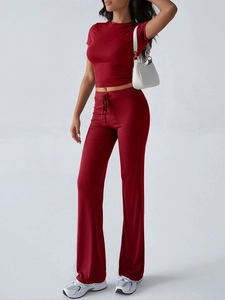 Detail of red two-piece set featuring cropped round neck t-shirt and high waist flare pants