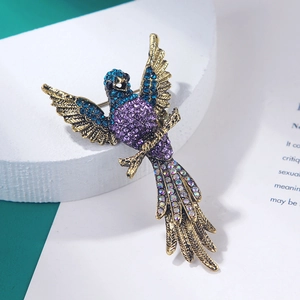 Detailed view of vintage eagle brooch with colorful purple and blue rhinestones on metal
