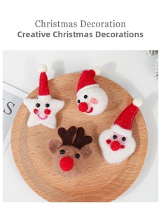 Detail of four handmade wool felt Christmas ornaments including Santa, reindeer, and snowman