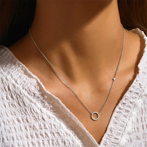 Macro detail of S925 sterling silver geometric circle necklace with pavé diamond accents