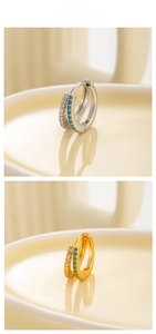 Detail of double-row earrings with sparkling white zircons and turquoise blue stones
