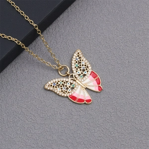 Detailed macro view of butterfly necklace with colorful enamel and crystal accents