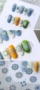 Detail of mandala nail stickers with gold outlines and colorful bohemian patterns