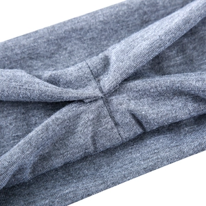 Close-up detail of dark grey knitted yoga headband with elastic twist knot design