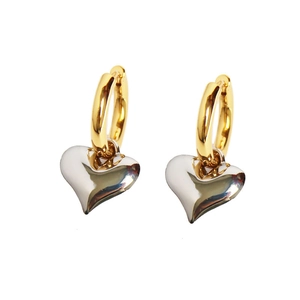 Vintage heart drop earrings with gold hoop and silver heart pendant on white background