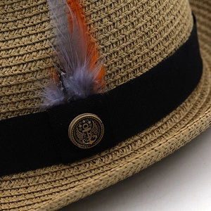 Straw sun hat with black grosgrain ribbon, colorful feathers and vintage metal badge