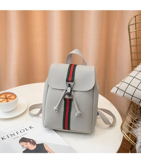 Detail of grey PU leather backpack with iconic red-green web stripe and metal buckle