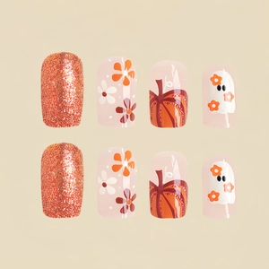 Glänzende Halloween-Nägel mit orangefarbenem Glitzer, Kürbis- und Geisterblumenmustern