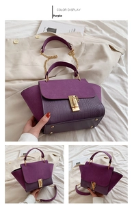 Close-up of purple crossbody bag with mix of matte leather and crocodile texture