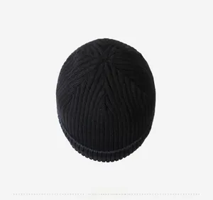Top down view of black ribbed knit beanie showing hexagonal crown stitching detail