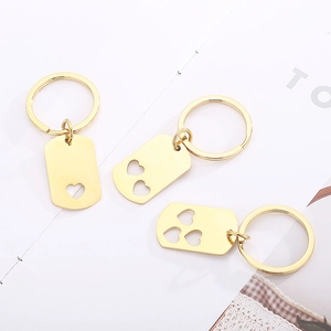 Three golden stainless steel keychains with heart cut-out rectangular pendants