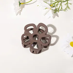 Matte coffee flower hair claw clip with internal metal spring on white background
