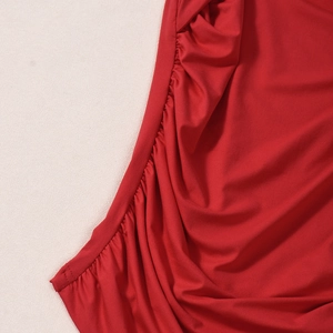 Detailed close-up of red high-elastic soft fabric with elegant ruched texture design