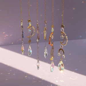 Detailed view of six gold suncatchers with moon and star celestial crystal pendants