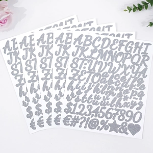 Silver glitter letter and number stickers showing alphabet and symbols in close-up detail