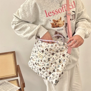 Quilted tote bag with cartoon puppy print, purple handles and pink shoulder strap detail
