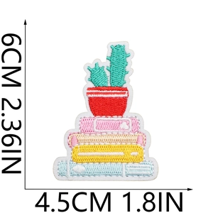 Detailed view of cactus and books embroidered patch showing 6x4.5cm size measurements
