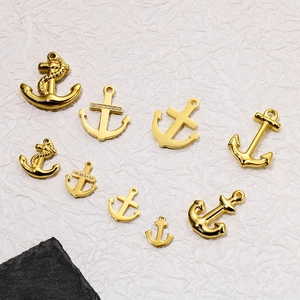 Various sizes of golden stainless steel anchor and helm pendants with crystal accents
