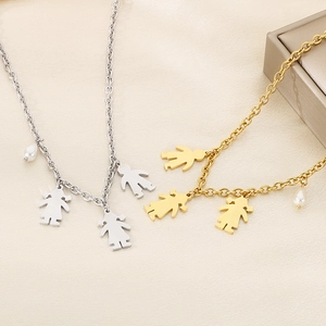 Detail of gold and silver boy and girl silhouette pendants with pearls on a metal chain
