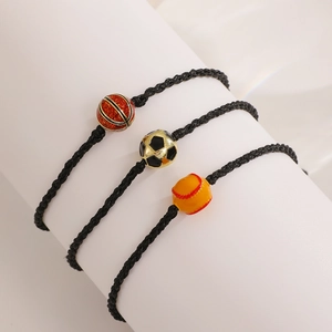 Detail of hand-woven black cord bracelets featuring basketball, football, and baseball charms