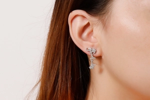 Close-up of silver mother and baby elephant stud earrings with heartbeat line design