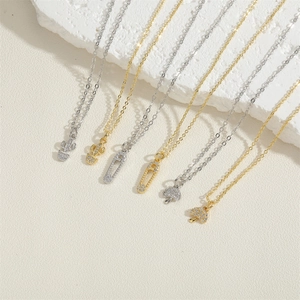 Minimalist 14K gold plated paperclip chain necklaces with zircon pendants on white stone