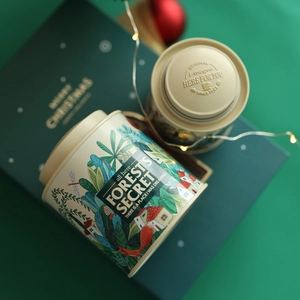Close-up of Forest's Secret mini rabbit tin with embossed lid and festive LED lights