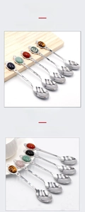 Detailed view of stainless steel dessert spoon with natural tiger eye crystal handle