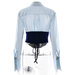 Detail showing the navy blue lace-up corset back on the light blue striped shirt