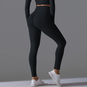 Rear view of black high waist seamless yoga set featuring peach lift leggings and crop top