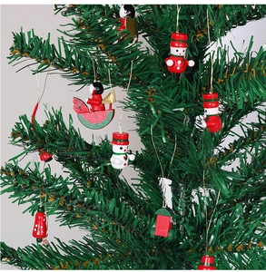 Close-up of wooden Christmas tree ornaments featuring snowman, angel and bells