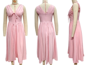 Detail view of pink V-neck sleeveless maxi dress with waist bow and flared A-line hemline
