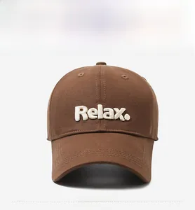 Close-up of white 3D Relax embroidery on a dark brown twill cotton baseball cap