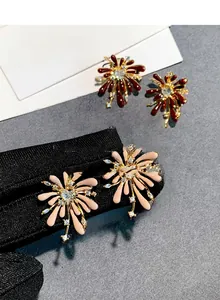 Detail view of fireworks enamel earrings with heart-shaped zircon and crystal accents