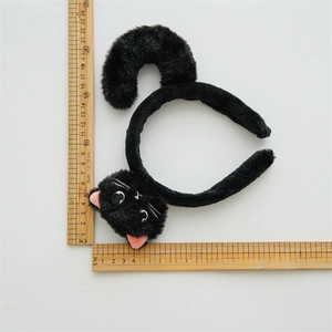 Cute black plush cat ear headband with embroidery and dimensions shown by rulers