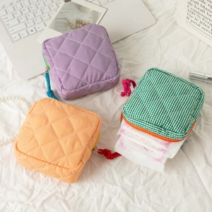 Detailed view of quilted gingham pouches used for storing feminine hygiene products