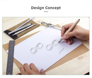 Macro design sketch of infinity silver stud earring with diamond accents on wood desk