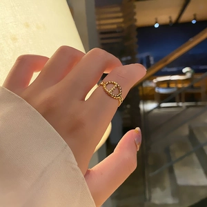 Close-up of 18k gold-plated stainless steel pig-nose ring on a female finger
