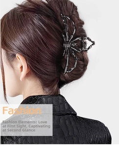 Close-up of a large black metal spider hair claw clip worn on a model in a leather jacket