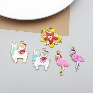 Detailed view of Christmas themed enamel charms featuring Santa on alpaca and flamingos
