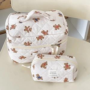 Close-up of quilted bear print makeup bags in large and small sizes with zipper