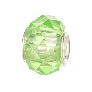 Close-up of a faceted transparent green resin bead with a polished metal inner ring