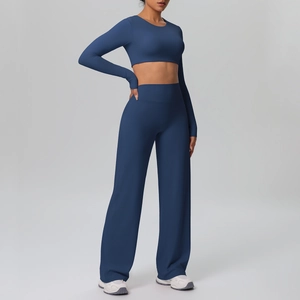 Detail of high-waisted wide-leg yoga pants and cropped long-sleeve athletic set in navy