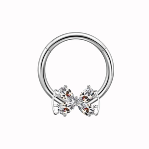 Silver nipple ring with four butterfly-shaped zircon crystals on a bright metal base