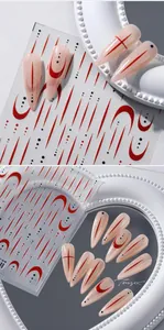 Detail of 5D 3D nail art stickers featuring pink base with red lines and black dots