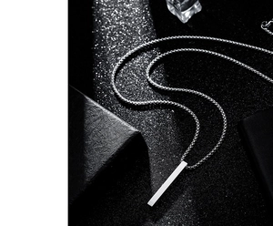 Macro shot of silver titanium steel column pendant with square link chain for men