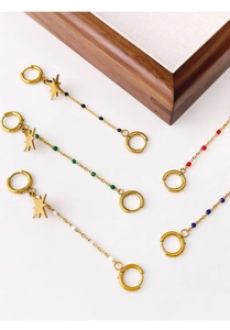 Detailed shot of golden chain hoop earrings with star pendants and colorful beads